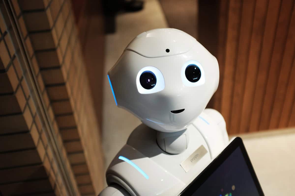 Cute AI robot with expressive eyes, used for enhancing customer interactions and operational efficiency.